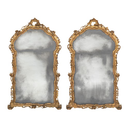A pair of North Italian carved giltwood rococo mirrors.